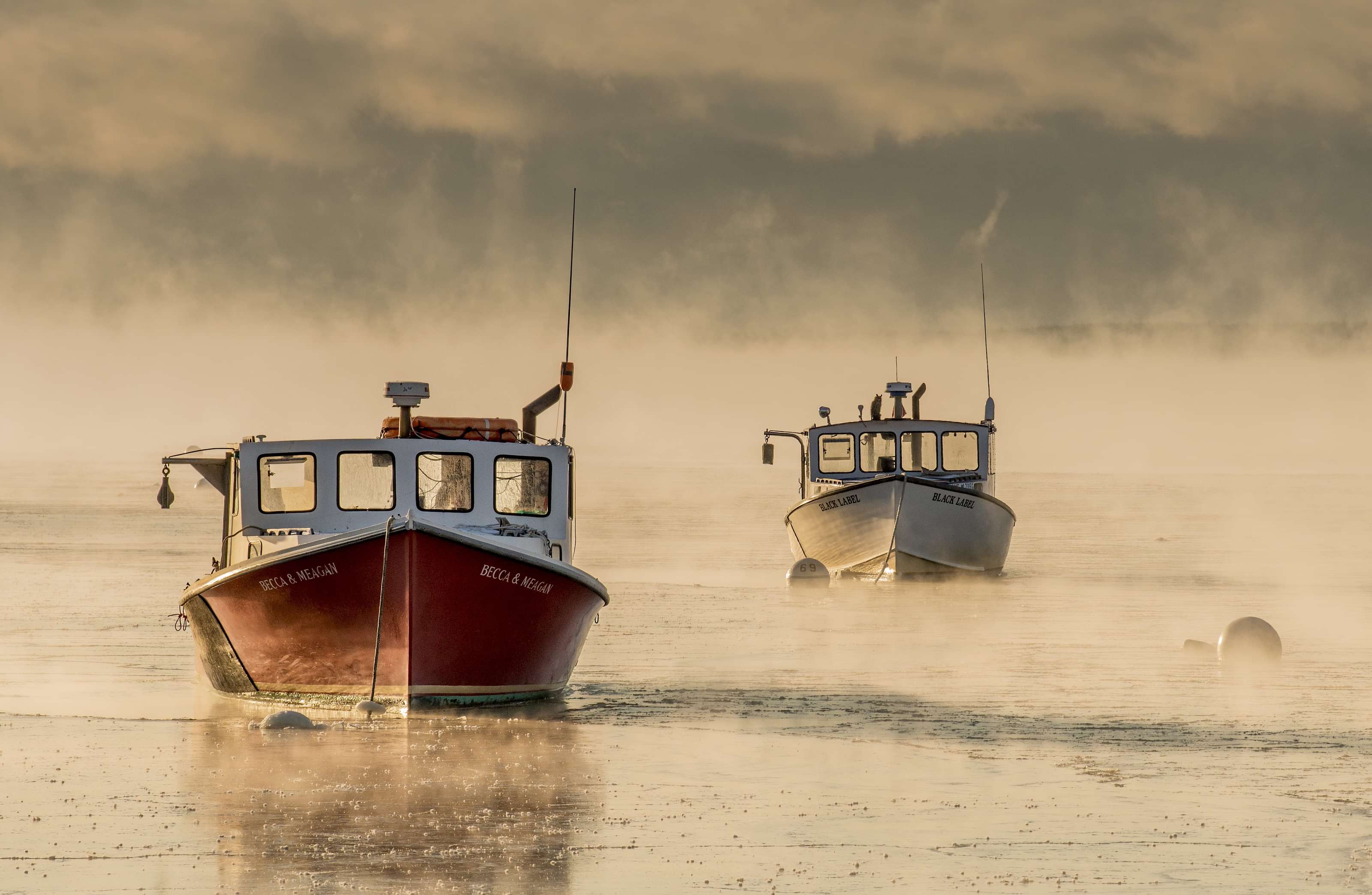 Maine lobster boats in sea smoke
